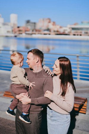 Photo for Portrait happy family mom dad and son walking around the city, having fun and enjoying spending time together on sunny day - Royalty Free Image