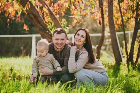 Photo for Portrait happy family mom dad and son having fun and enjoying spending time together in autumn park on sunny day. Love and loyalty, young parents - Royalty Free Image
