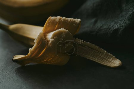 Photo for Close-up of peeled bananas on a dark background - Royalty Free Image