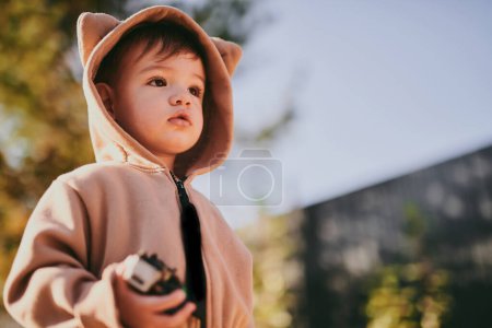 Foto de Retrato de primer plano del niño con traje de felpa de oso encapuchado. Bebé jugando afuera - Imagen libre de derechos