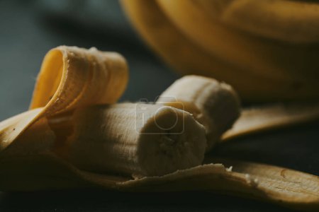 Foto de Primer plano de plátanos pelados sobre un fondo oscuro - Imagen libre de derechos