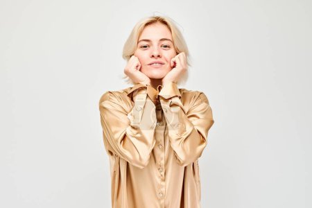 Téléchargez les photos : Portrait jeune femme blonde souriante joyeux toucher heureux choqué visage isolé sur fond de studio blanc, banne publicitaire - en image libre de droit