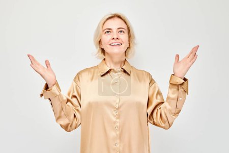 Photo for Portrait blond young woman happy face smiling joyfully with raised palms and shocked open mouth isolated on white studio backgroun - Royalty Free Image