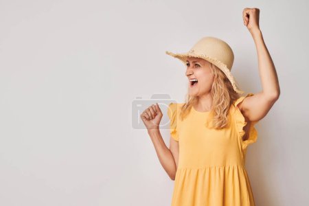 Photo for Portrait of smiling face adult woman clenching fists and rejoicing, celebrating victory isolated on white studio background, advertising banne - Royalty Free Image