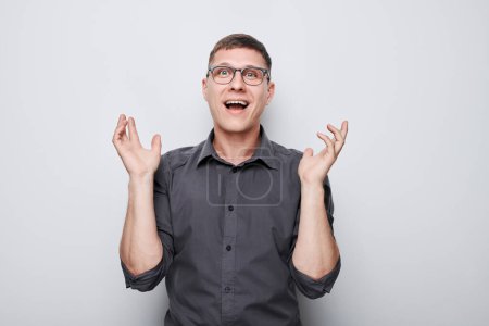 Photo for Portrait man happy face smiling joyfully with raised palms and shocked open mouth isolated on white studio backgroun - Royalty Free Image