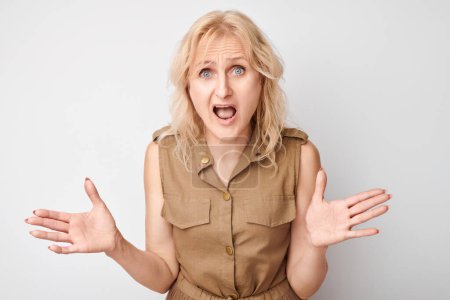 Photo for Portrait of adult woman screaming with anger, freaking out, breakdown on white background. Depression, uncertainty, nervous stress concep - Royalty Free Image