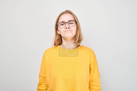 Portrait of student girl with sad face offended and crying on white background. Nerves, stress, uncertainty concep