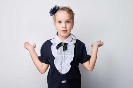 Photo for Surprised young girl wearing dress with collar gesturing with hands isolated on a light background. - Royalty Free Image