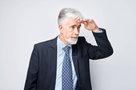 Photo for Senior businessman looking away with hand on forehead, concern or deep thought on light background - Royalty Free Image