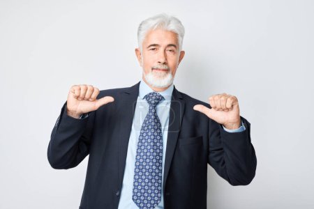 Photo for Confident senior businessman pointing at himself with thumbs, smiling isolated on light background - Royalty Free Image