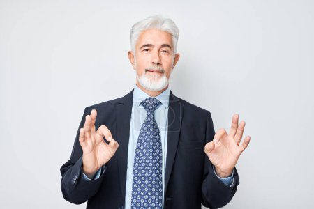 Photo for Senior businessman making OK gesture with hand isolated on white background. - Royalty Free Image