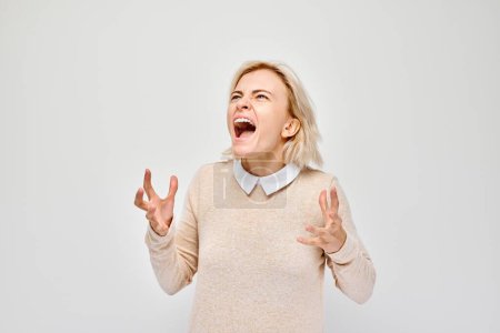 Photo for Portrait of girl screaming with anger, freaking out, breakdown on white background. Depression, uncertainty, nervous stress concep - Royalty Free Image