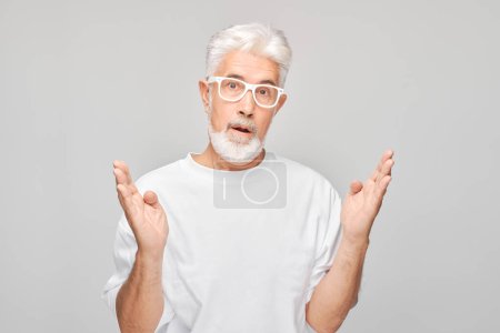 Photo for Portrait gray-haired man happy face smiling joyfully with raised palms and shocked open mouth isolated on white studio backgroun - Royalty Free Image