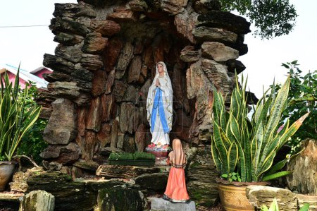 Statue of Our lady of grace virgin Mary view with natural background in the rock cave at Thailand. selective focus.