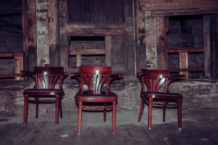 Three chairs in an old and dirty basement