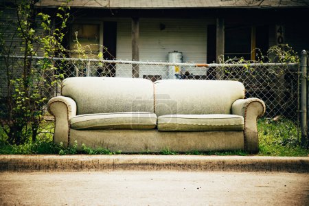 Old couch standing on the curbside to be trashed