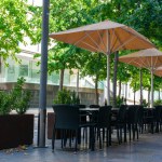 Cafe on the open air. Chairs and tables outside on the summer sun weather in Spain. Design of furnitureset for summer cafe or restaurant.