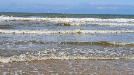 Wunderschönes Meer mit Sand, Yachten, Wellen auf dem Wasser und blauem Himmel. Natürlicher Hintergrund für den Sommerurlaub.