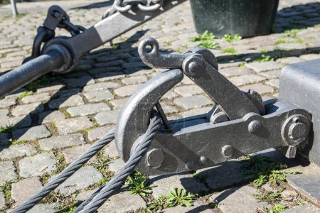 Fastening for anchor of the ship on a embankment in a port, near a river.
