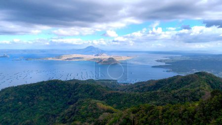 Taal island volcano in the middle of the lake, lava walls and crater  and rocks landscape around