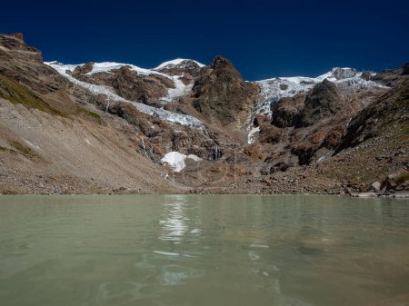 View of Lyskamm mountain, Lys glacier and lake in summer on Monte Rosa massif, in Valle d'Aosta, north Italy. Retreating because of climate change