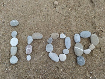 With the help of pebbles, Igor's name is represent on the sand