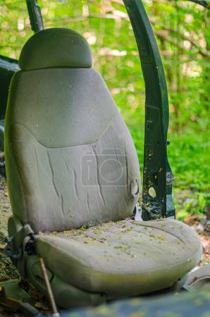 Old car seat in abandoned car in forest.. High quality photo