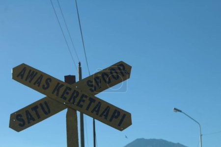 A warning sign before crossing a railway crossing in Semarang, Indonesia on December 25, 2017.