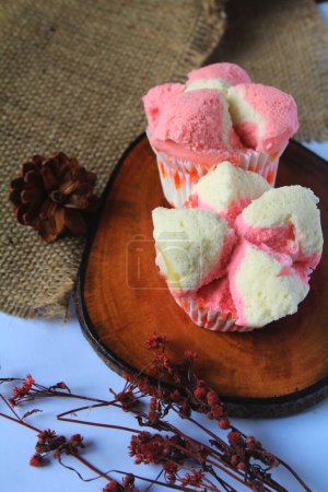 Bolu Kukus or steamed cupcakes are simple market snacks made from wheat flour, eggs, sugar, baking soda and milk powder until they break out when fully cooked Semarang, Indonesia on March 27, 2021.