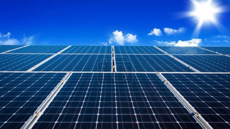 Photo for Renewable energy concept: Solar panels under clear blue sky and sun. - Royalty Free Image