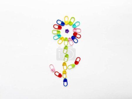 Knitting Markers Arranged into a Flower with a Button Center
