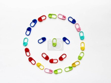 Colorful Knitting Stitch Markers Arranged in Circular Pattern