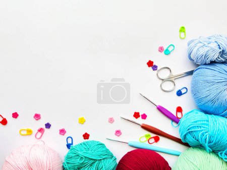 Colorful Yarn, Scissors, Crochet Hooks, and Knitting Markers Craft Setup