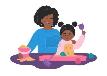 Madre con niño juega con arena y juguetes en caja de arena de plástico sobre la mesa.