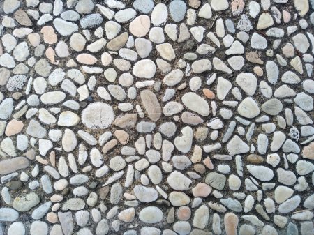 Téléchargez les photos : Round stone floor background. Gravel floor texture background. Floor background with stones. Rocks on the path for health - en image libre de droit