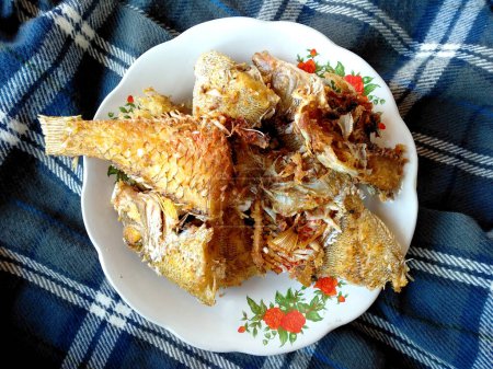 traditional indonesian culinary food. Ikan Goreng or fried fish. Ikan Goreng Indonesian Food that is simple and often made at home. Indonesian Street Food ( fried fish )
