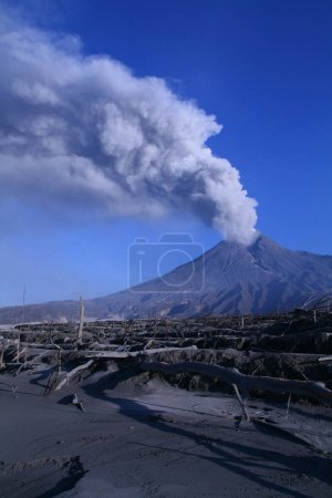 The eruption of Mount Merapi in Yogyakarta, Indonesia. Blue sky background