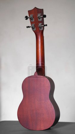 Téléchargez les photos : Back of ukulele guitar made of wood on a white background - en image libre de droit