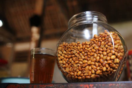 Fried soybeans in a glass jar. Crunchy and savory snack. Very good to eat while accompanied by a warm drink