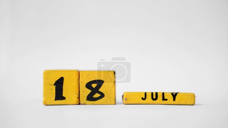JULY 18 Wooden calendar. Nelson Mandela International Day. White background with space for your text
