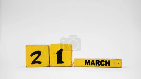 MARCH 21 Wooden calendar. World Poetry Day. World Down Syndrome Day. International Day of Forests. White background with space for your text.