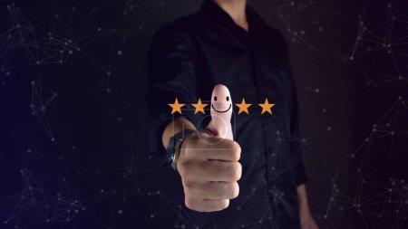 business man thumbs up to hit the smiley face great customer rating Customer Satisfaction Concept