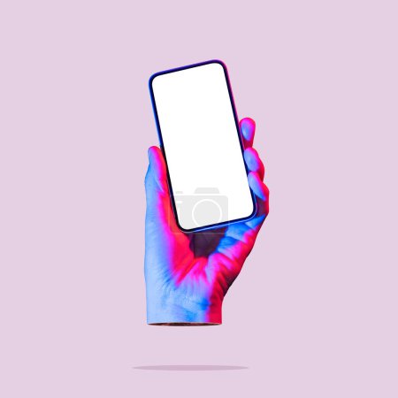 Photo pour The hand holds a smartphone with a white screen. Art collage. Mockup. - image libre de droit
