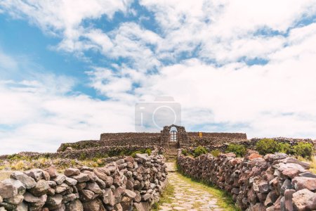 stone arch on top of a mountain on the island of amantani in puno peru on lake titicaca