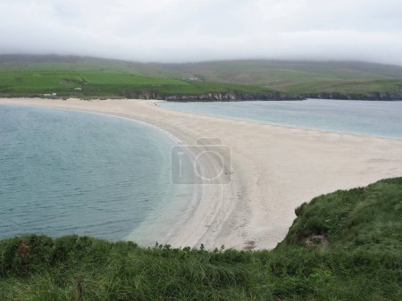 St Ninians beach, a tombolo in the Shetland Islands. St Ninian's (or St Ninian) Isle is a small tied island connected by the largest tombolo in the United Kingdom to the south-western coast of the Mainland, Shetland islands, in Scotland.