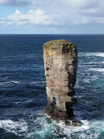 Yesnaby Castle sea stack and cliffs. Orkney islands. Scotland. A spectacular Old Red Sandstone coastal cliff scenery. The area is popular with climbers because of Yesnaby Castle, a two-legged sea stack.