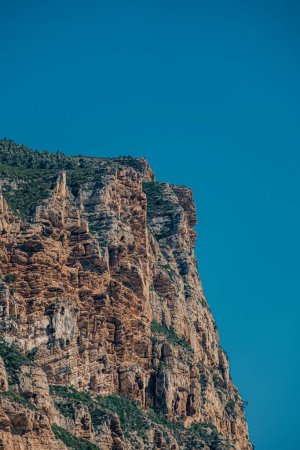 Rugged cliff face with dense vegetation in Marseille