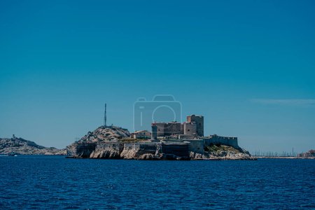 Historic island fortress in the blue waters near Marseille.