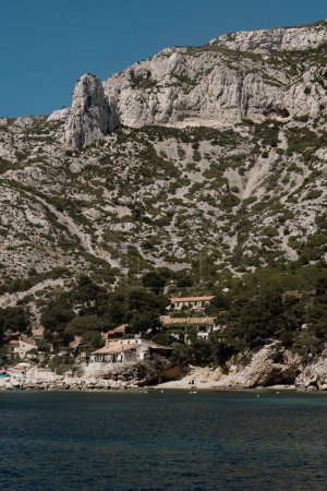 Seaside village nestled under the towering Calanques cliffs.