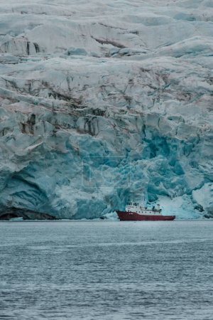 Expedition ship near massive glacier in Longyearbyen, Svalbard